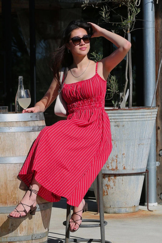 Valentina Scarlet lifestyle — women's red pinstripe cotton midi dress styled at a winery in natural light