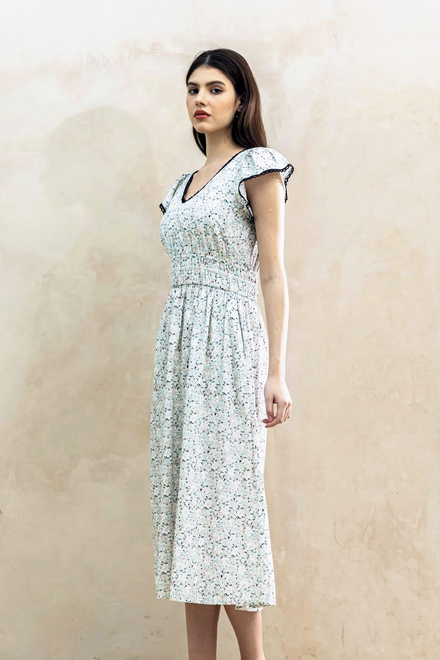 Juliet Black Blossom lifestyle — women's black floral cotton dress styled outdoors in natural light