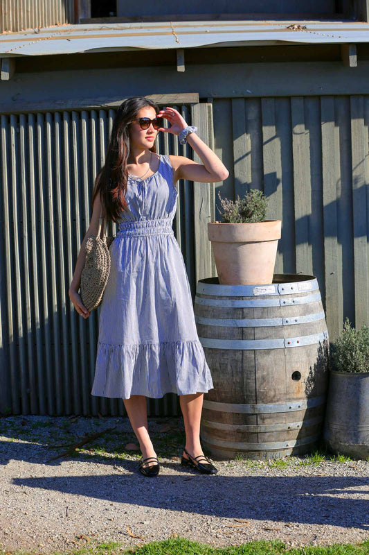 Martina Midnight lifestyle — sleeveless navy pinstripe cotton dress