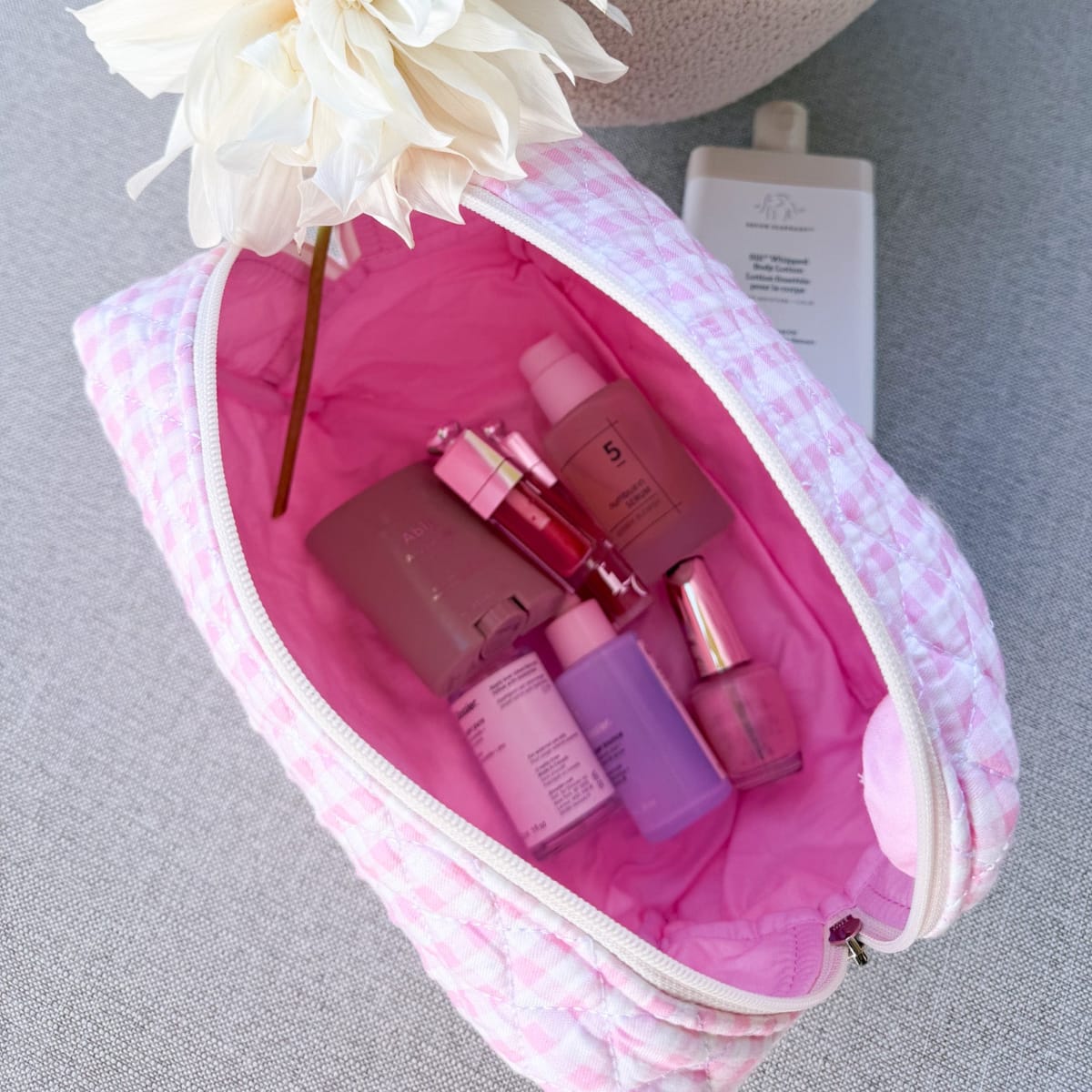 Gingham Pink Make-up Bag Large — pink gingham cotton travel bag held in hand