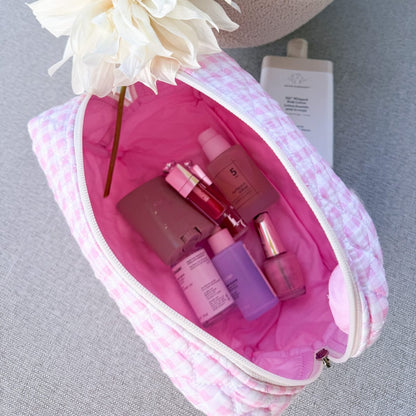 Gingham Pink Make-up Bag Large — pink gingham cotton travel bag held in hand
