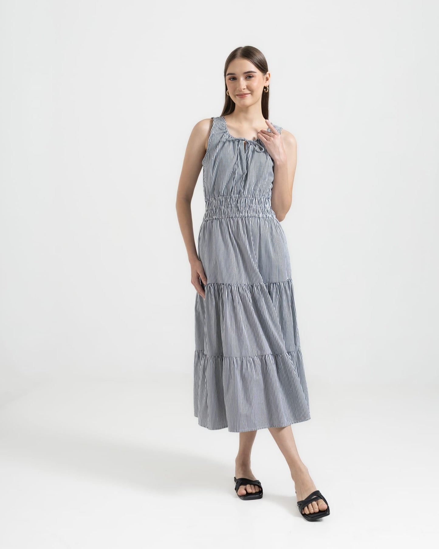 Martina Midnight front view — navy pinstripe cotton midi dress with front ties and A-line silhouette