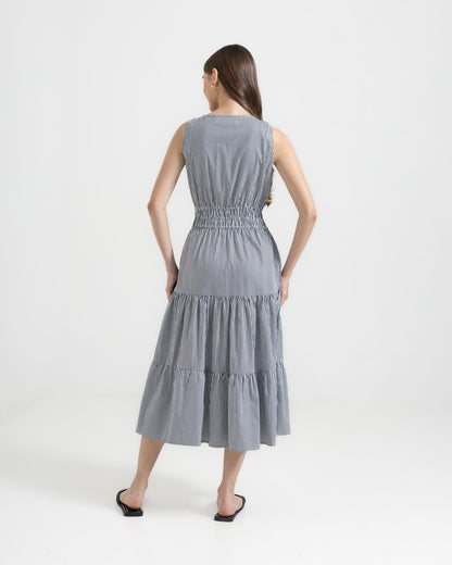 Martina Midnight back view — navy pinstripe cotton dress with tiered skirt and deep side pockets