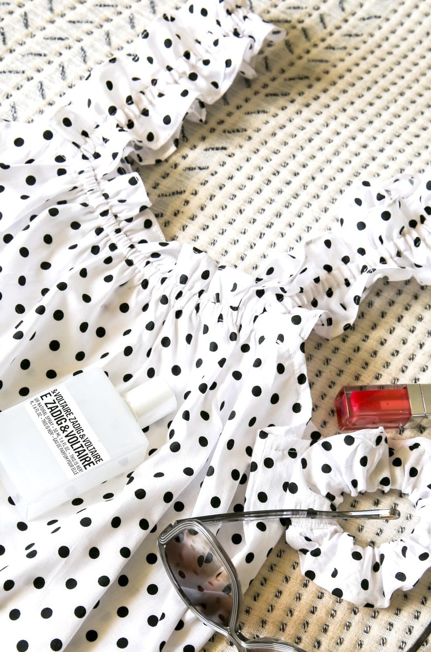 Mila Milk back view — women's white polka dot cotton mini dress with slim straps and flowing silhouette