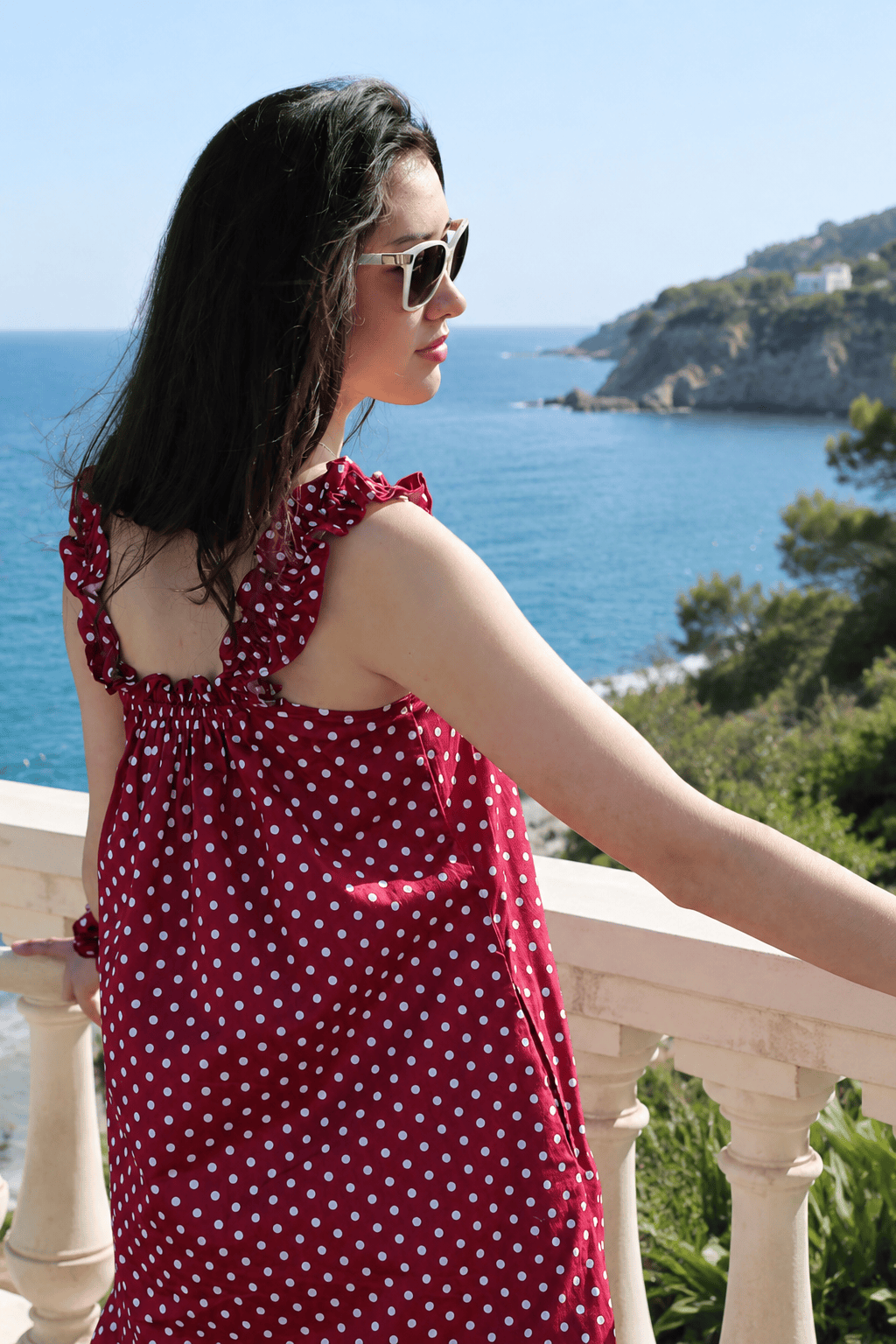 Mila Red lifestyle — women's red polka dot cotton summer dress in natural light
