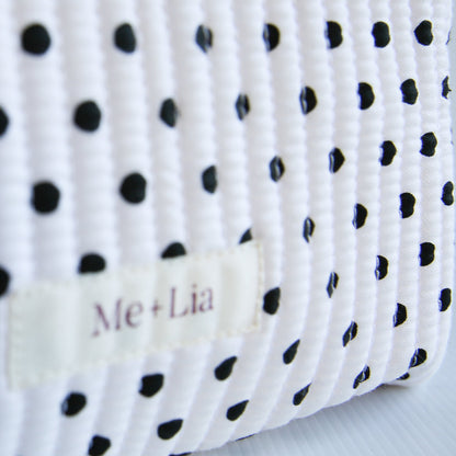 Polkadot Black Make-up Bag Large — black polka dot cotton travel bag held in hand