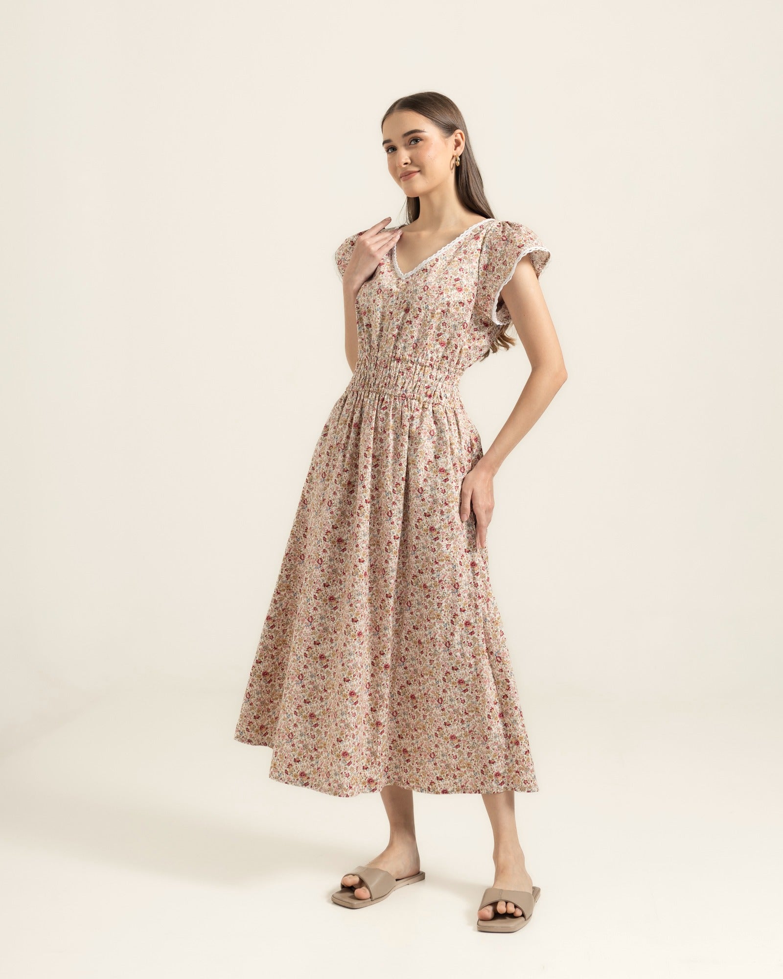 Juliet Wildflower dress three-quarter view — flutter sleeves and gathered waist on cream floral cotton