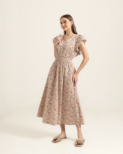 Juliet Wildflower dress three-quarter view — flutter sleeves and gathered waist on cream floral cotton
