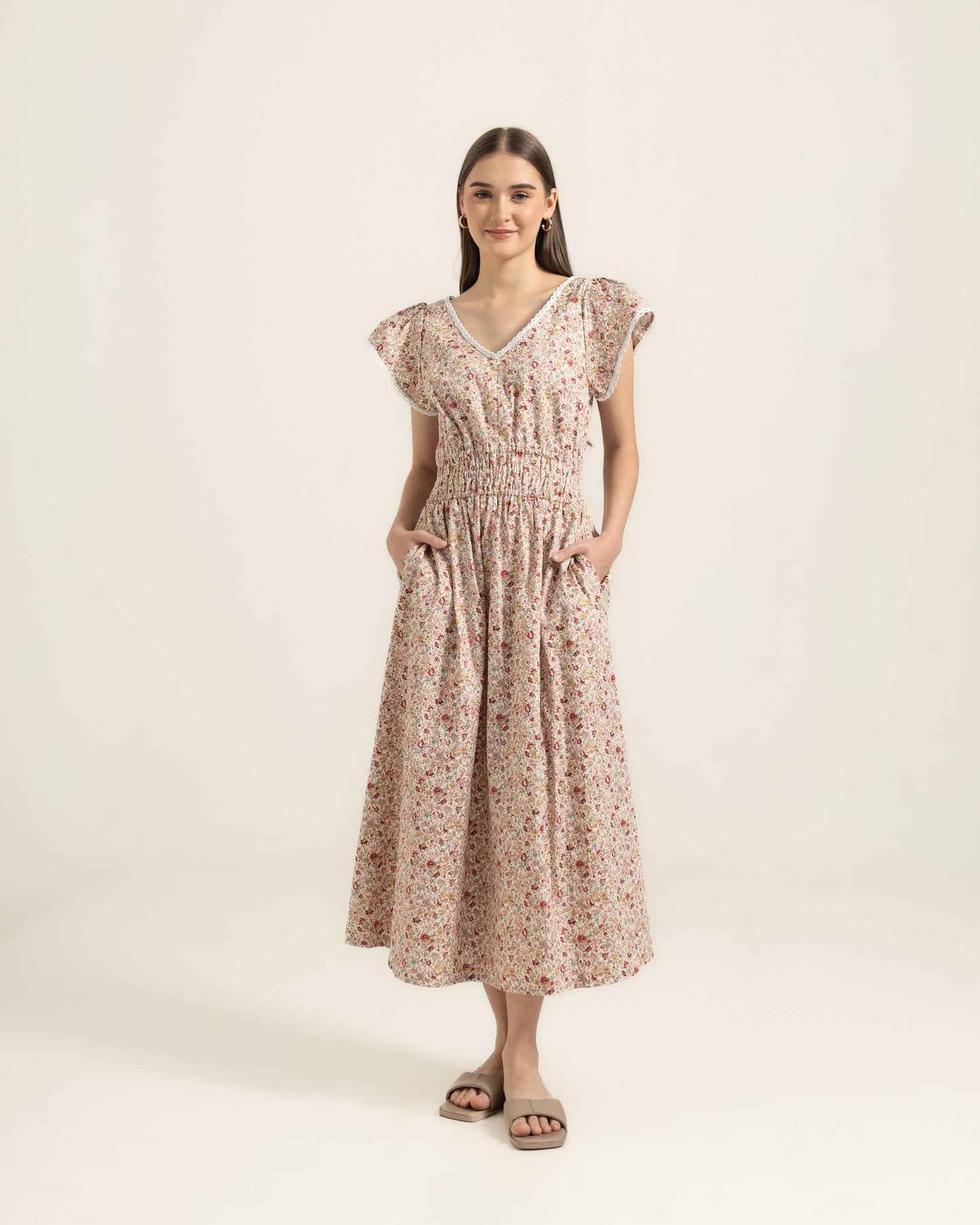 Juliet Wildflower dress studio front — V-neck lace trim, shirred waist and full cotton skirt with deep pockets