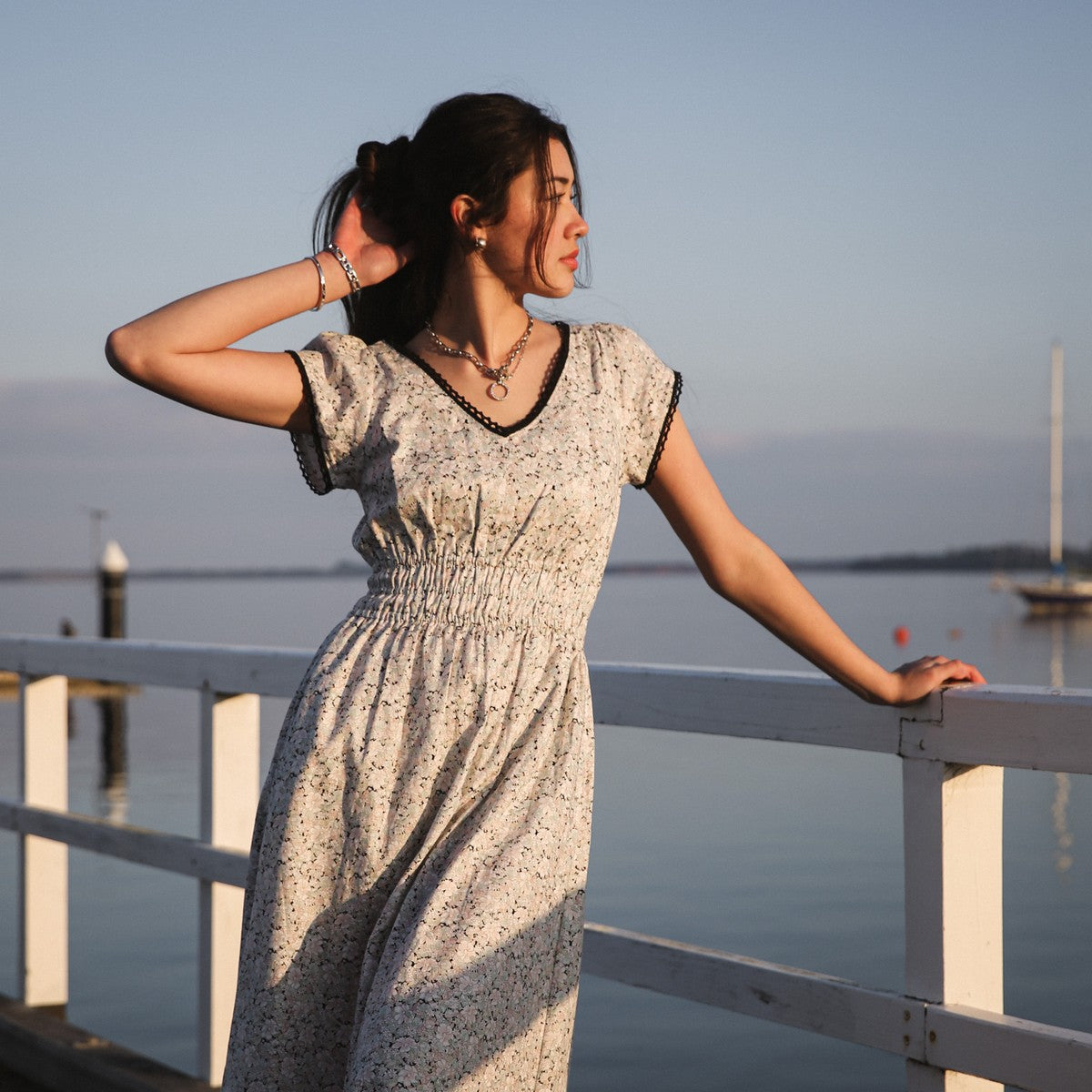 Juliet Black floral midi dress portrait at the railing