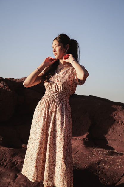 Juliet Wildflower ditsy floral dress at the cliffs, gazing toward the horizon