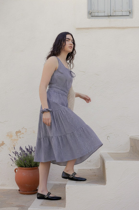 Martina Midnight navy pinstripe cotton midi dress on whitewashed Mediterranean steps