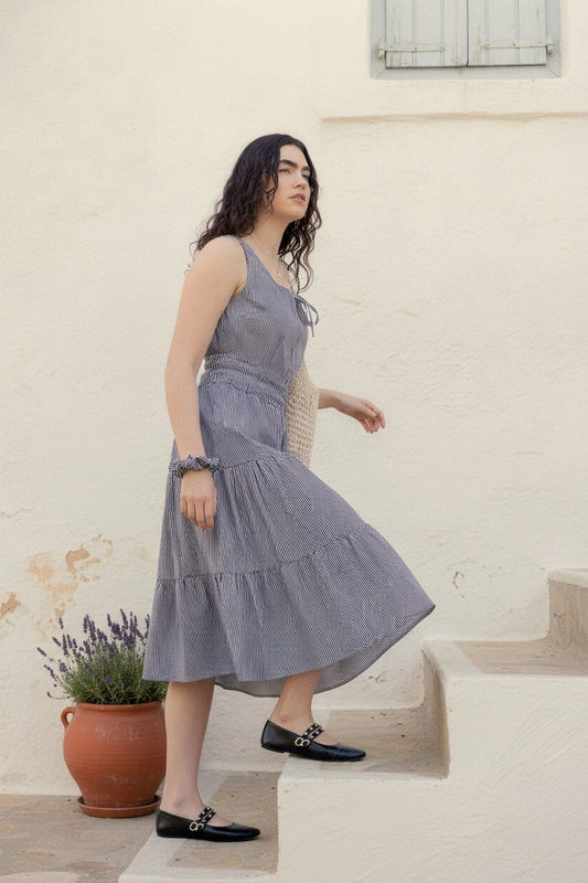Martina Midnight navy pinstripe cotton midi dress on whitewashed Mediterranean steps