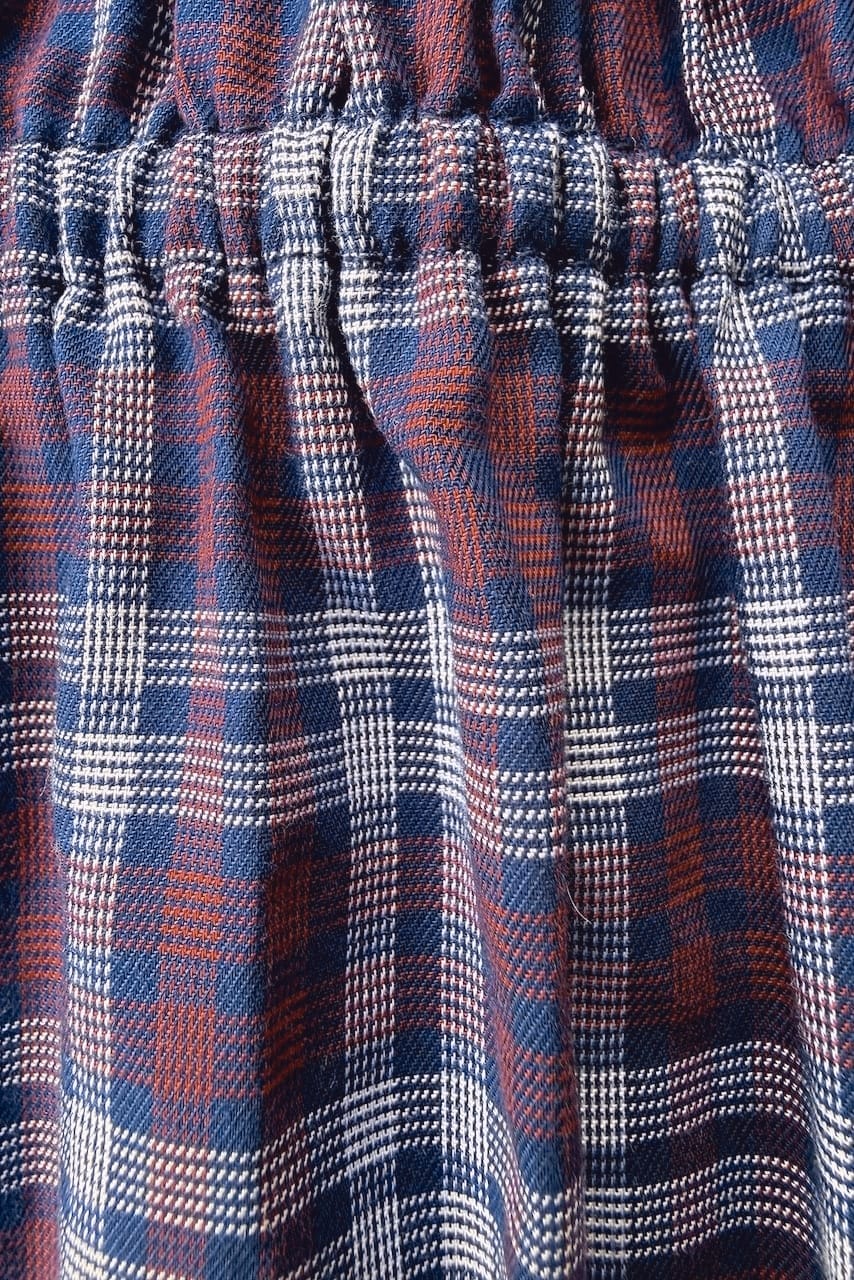 Tassia Plum fabric detail — navy and plum plaid in premium repurposed cotton