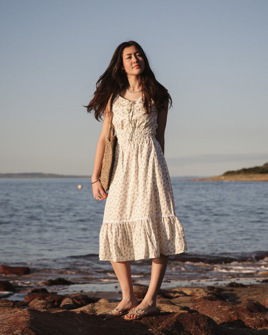 Bianca Rose striped cotton midi dress on red coastal rocks