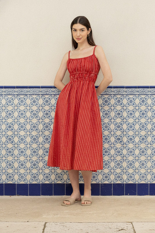 Valentina Scarlet lifestyle - women's scarlet red pinstripe cotton midi dress worn against a blue and white tiled Lisbon wall