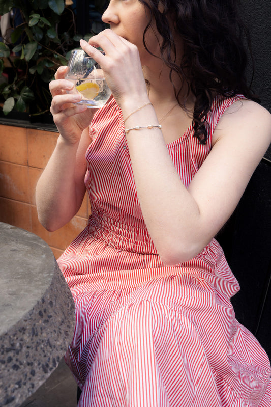 Martina Red Daydream Dress in a timeless red and white French-inspired stripe with a relaxed silhouette and flowy tiered skirt.